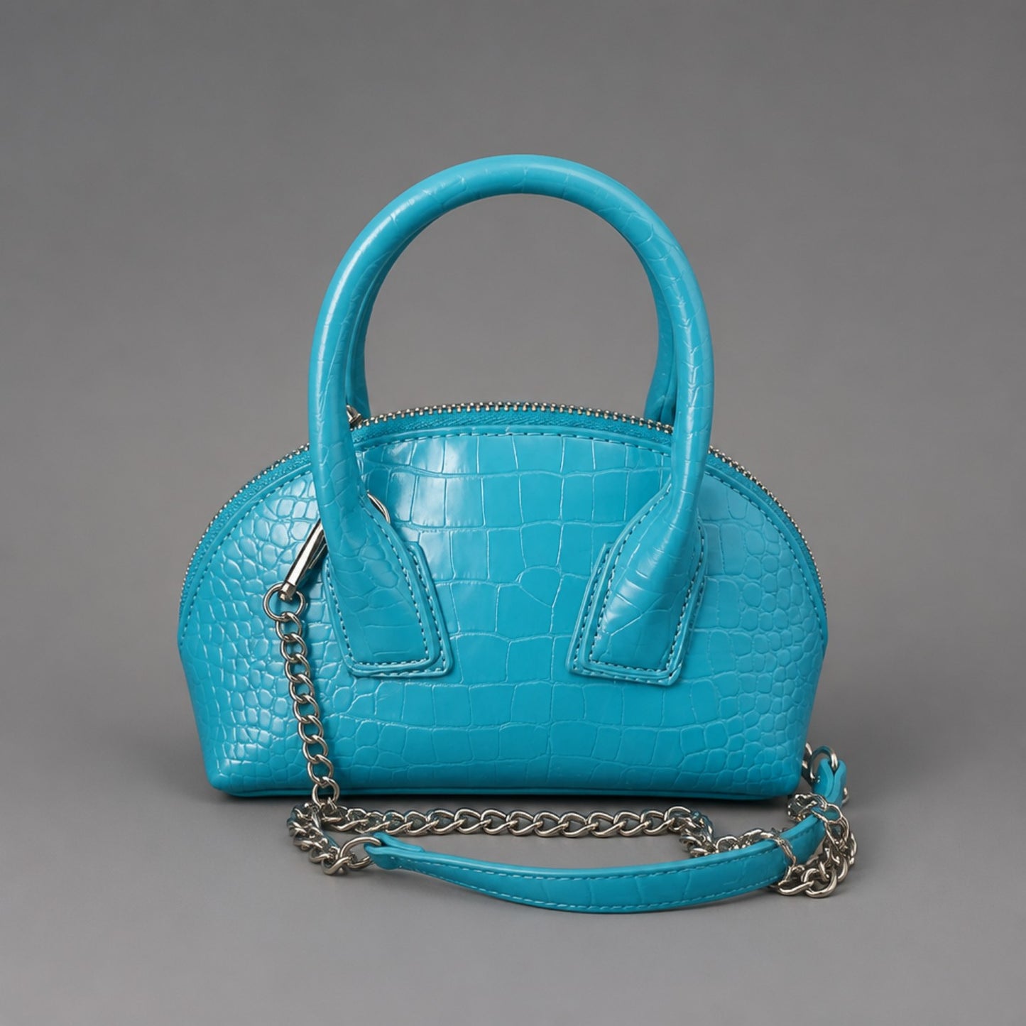 Handtasche in Türkis mit Kroko-Prägung – trendiges Statement-Piece Tasche Das Zierwerk